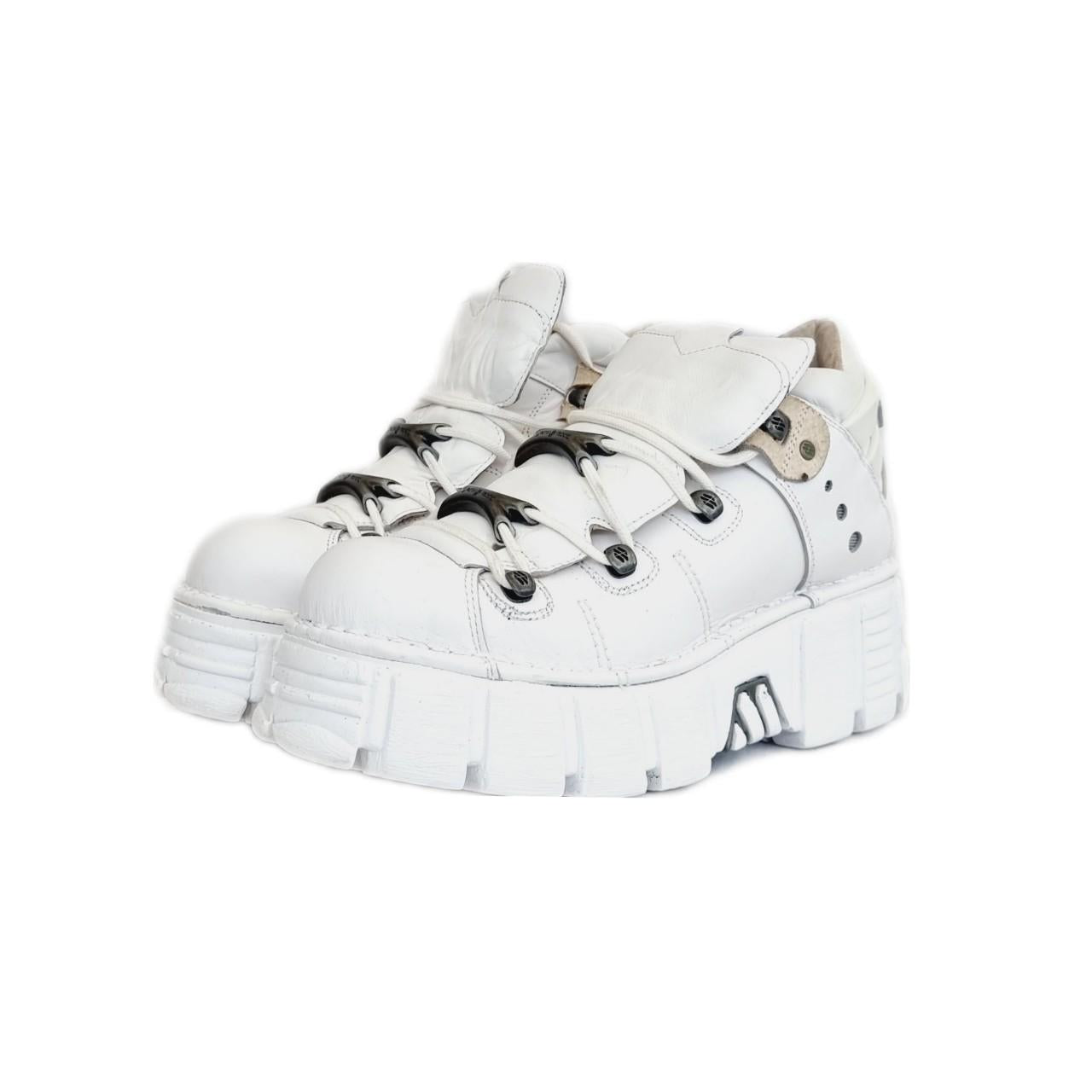 White leather silver metal and bold white rubber sole New Rock tower boots with lace up fronts and huge platforms. The platform is pretty lightweight as they go and made of a high quality anti aqua planing rubber.