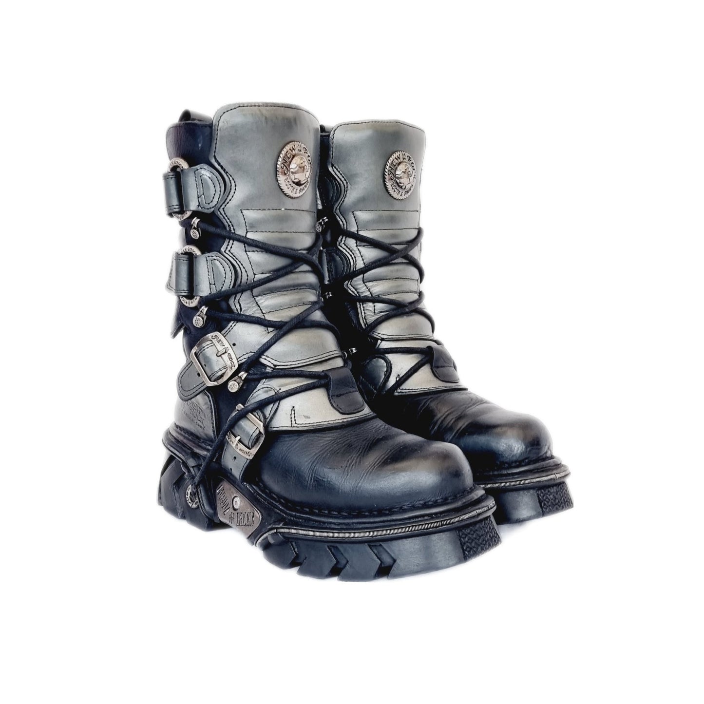 Vintage leather and metal heeled New Rock boots with lace up fronts and buckled straps. Black and silver, they sit about half way up the calf. The buckles and laces are fully adjustable, but there are also inside zips for ease of use. Like most New Rocks these have chunky platforms, but they aren't so big they can't be used daily. Rather than a full-on platform, the sole is a couple of inches, made of high quality anti aquaplaning rubber from the 90s / y2k era