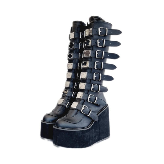 Black Demonia swing knee high boots with front detail mirrors, buckles, zips and huge platforms perfect for festivals and rave wear. 