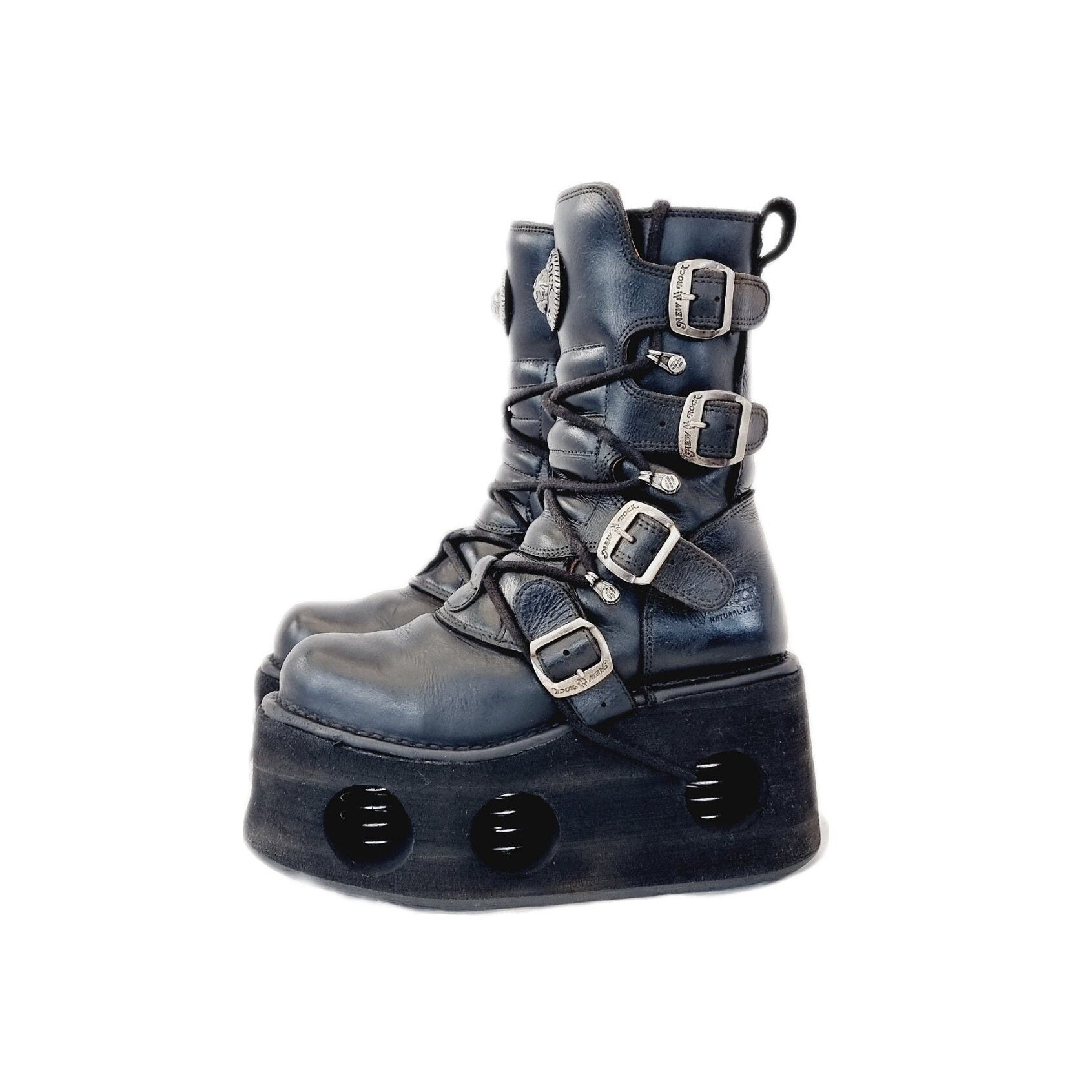 Vintage leather, rubber and metal New Rock boots with velcro buckled straps. Black and silver, they sit about half way up the calf. They sit upon huge Neptuno style platforms made of high quality dense foam. 